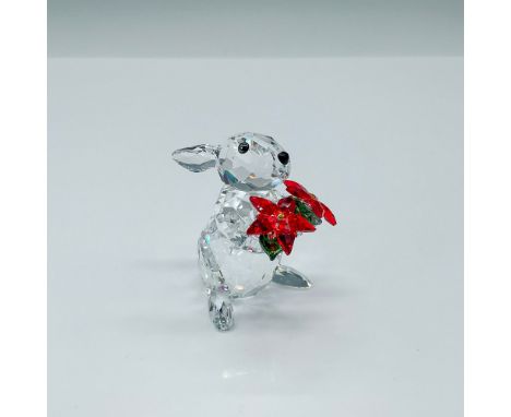 This adorable clear crystal rabbit holds the Poinsettia, a classic symbol of Christmas. The flower sparkles in Light Siam and
