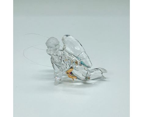 A beautiful clear crystal angel, adorned with frosted face, hands, and feet, enhanced by gold belt accents for a touch of gra