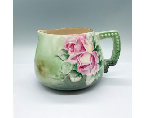 A round light green pitcher adorned with pink, purple, and yellow roses. CAC Belleek palette backstamp.Dimensions: 9"L x 7.5"