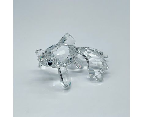 Depicts a clear crystal telescope fish standing on its fins with teal-colored eyes. This item has its original box which meas