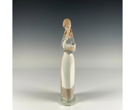 Glossy finish figure depicting a young girl delicately carrying a goose in her arms. Nao by Lladro backstamp. Artist: Fulgenc