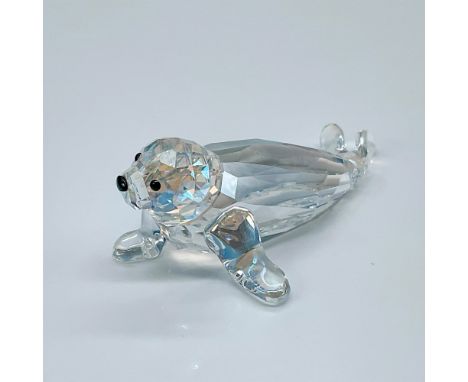 Clear faceted head, body with smooth fins, black eyes and nose. Swarovski backstamp. 1096748. This item has its original box 