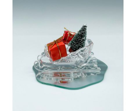 This Swarovski crystal sleigh was part of the Exquisite Accents group and comes with 2 wrapped presents and a small tree. Swa