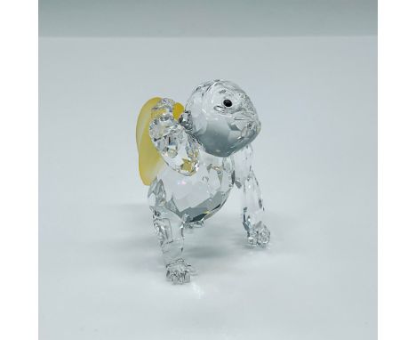 Part of the 'Rare Encounters' series. A clear faceted body with black crystal eyes. The gorilla is carrying frosted jonquil c
