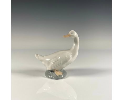 Glossy finish figure of a duck with its neck turned, standing on a rock. Nao by Lladro backstamp. Artist: Jose RoigIssued: 19