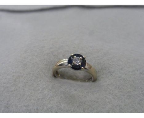 An 18k white gold, diamond and sapphire ring, size K. 