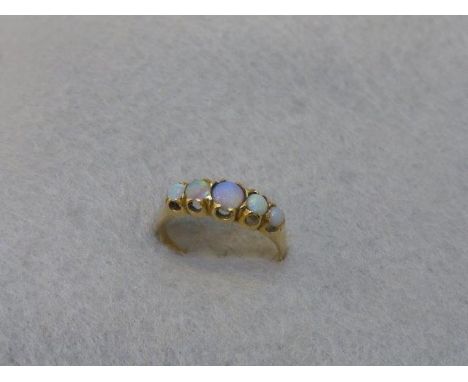 A ladies 18ct gold opal ring with five stones, size M.