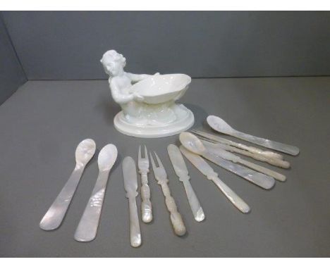 A Royal Worcester salt in the form of a mermaid holding a shell, model no 349 and four mother of pearl knife, fork and spoon 