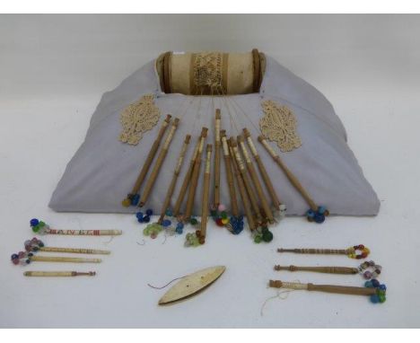 Yesterday's World Museum Lacemakers -a lace roller in progress with bobbins attached plus a selection of extra loose bobbins,