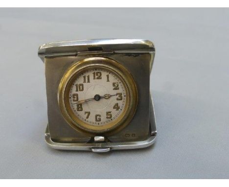 A silver travelling watch, with engine turned decoration by repute in working order, Birmingham 1925.