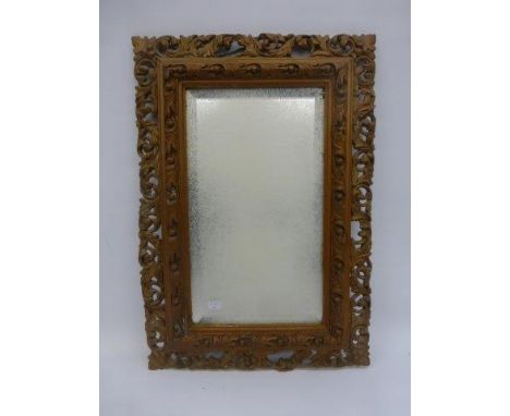 A 19th Century gilt wall mirror with a carved acanthus frame. 