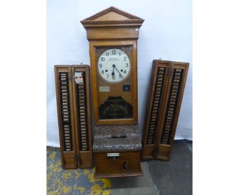 A National Time Recorder Co. Limited oak cased clocking-in clock, flanked by two cased card holders. 