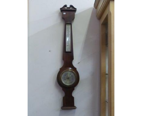 A contemporary aneroid barometer with a silver dial. 