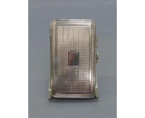 A silver cigarette case with engine-turned decoration, maker: JR Birmingham 1929.
