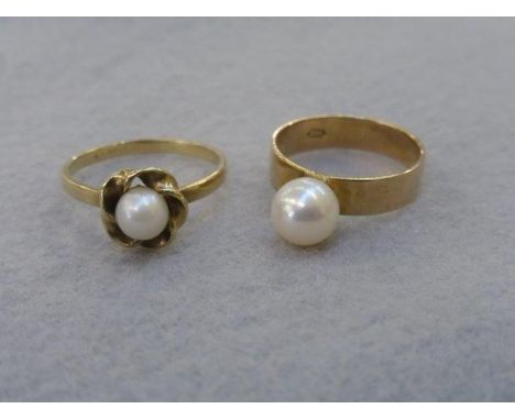 Two gold rings, one 9ct, the other 14k, both set with a single pearl, sizes O and R.