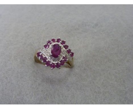 A gold (unmarked) ruby and diamond set ring of unusual design, size N.