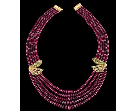 A five strand ruby beads necklaceGold clasp and applied elements Green enamel decoration and set with 20 brilliant cut diamon