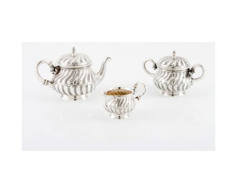 A tea set LEITÂO & IRMÂOTeapot, milk jug and sugar bowlPortuguese silverReliefs and spiralled decorationBoar hallmark 833/100