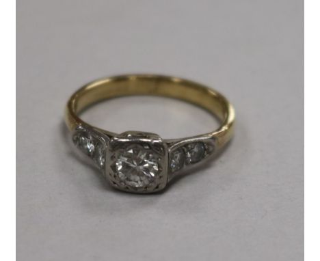 A yellow metal and single stone diamond ring with diamond set shoulders, size O.