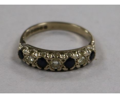 A 1970's 18ct gold and graduated seven stone sapphire and diamond half hoop ring, size N.