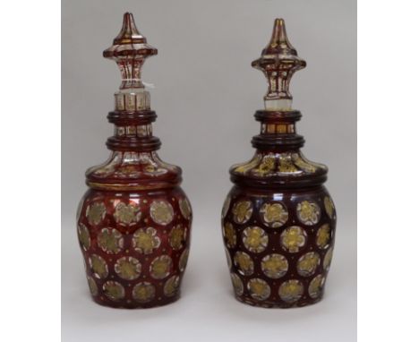 A pair of Bohemian gilt and ruby flash cut decanters with spear stoppers height 34cm