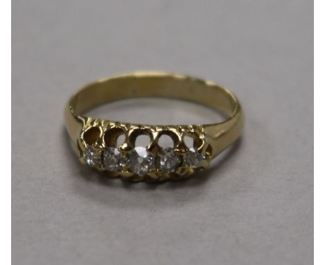 A yellow metal and graduated five stone diamond ring, size K.