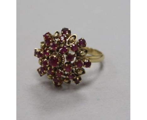 A 14ct ruby and diamond cluster dress ring, size N.