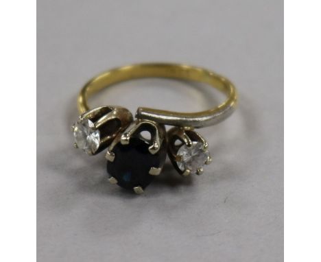 An 18ct gold and three stone sapphire and diamond ring, size N.