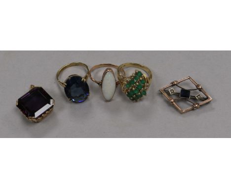 Two 9ct gold rings, a 14ct gold gem set ring, a yellow metal and gem set brooch and a yellow metal and gem set pendant.