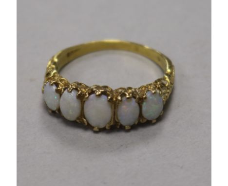 A 9ct gold and graduated five stone white opal ring, size T.