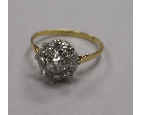 A mid 20th century 18ct gold and diamond cluster ring, size O.