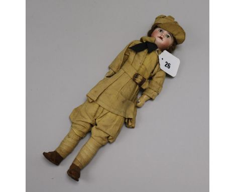 A French bisque head doll dressed in WWI army uniform length 33cm