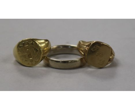 An 18ct gold signet ring, a 9ct gold signet ring and an 18ct gold white gold wedding ring.