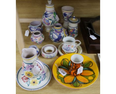 A collection of Poole Pottery, including thirteen items decorated with flowers and birds, comprising a lamp base, five vases 