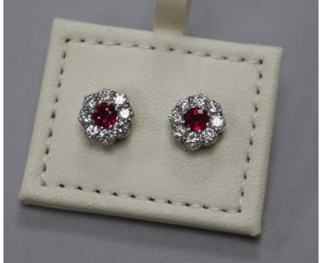 A pair of 18ct ruby and diamond cluster flower head earrings, 8mm.