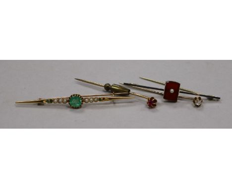 An early 20th century yellow metal, seed pearl and emerald bar brooch, a 15ct? gold bar brooch and two stick pins, one set wi