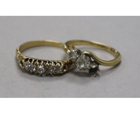 An 18ct gold and graduated five stone diamond ring and an 18ct gold and two (ex 3) stone diamond crossover ring.