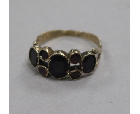 A George III yellow metal and foil backed gem set ring, with central doublet stone, size M.