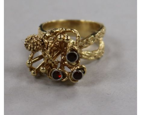 A 1970's? 14ct gold and garnet set rustic cocktail ring, size M.