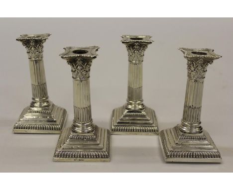 Set of four early 20th Century silver Corinthian column candlesticks on square stepped bases, Sheffield 1924, 6.25ins highNum