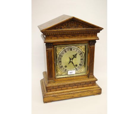 Late 19th Century oak mantel clock with architectural arched case and half pilasters, the silvered and gilt dial with Arabic 