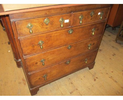 18th Century oak straight front chest of two short and three long graduated drawers with brass drop handles and brass escutch