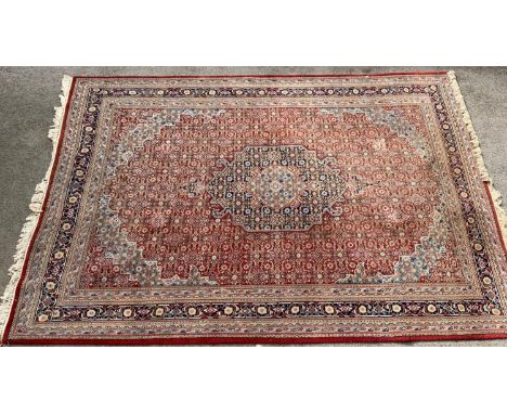 Indo Persian carpet with a medallion and all-over Herati design on a red ground with multiple borders, 12ft x 8ft 6ins approx