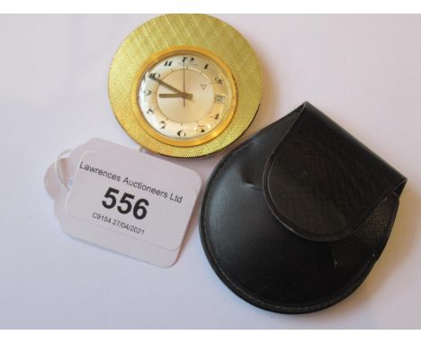 Small Jaeger le Coultre gold plated travel alarm clock with an engine turned circular case, silvered dial, Arabic numerals, d