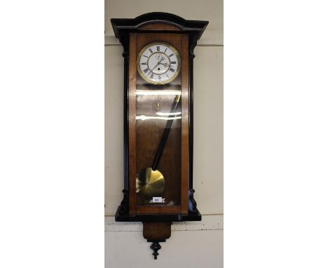 Vienna walnut and ebonised wall clock, the white enamel dial with Roman numerals and subsidiary seconds, with a single train 