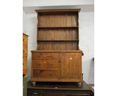 Small 19th Century stripped pine dresser, the boarded shelf back above three drawers beside a single cupboard door on low tur