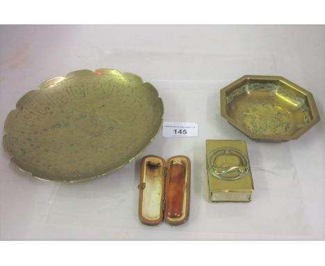 German Trench Art brass match box cover, a 9ct gold mounted simulated amber cheroot holder and two small brass dishes 