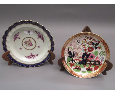 18th Century Worcester dish painted with a central polychrome floral spray and puce floral sprays within a scalloped edge wit