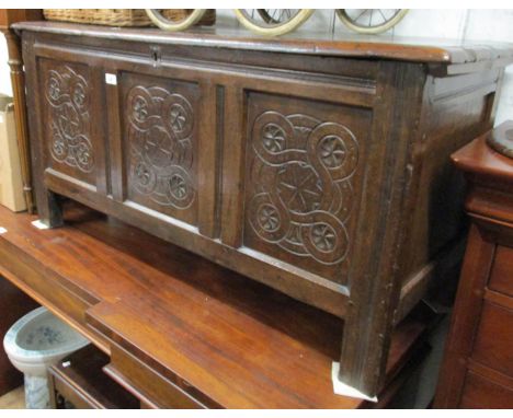 17th Century oak coffer, the hinged moulded two plank lid above a carved three panel front on stile supports, 48ins wide 