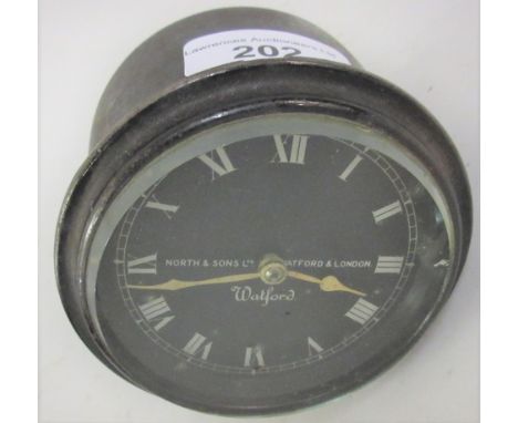 North & Sons Ltd., Watford and London, car / aeroplane early 20th Century dashboard clock having black dial with silvered Rom